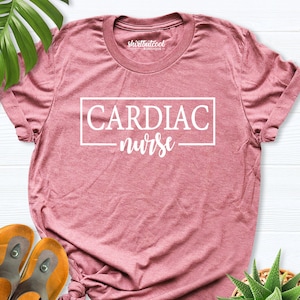May include: A pink t-shirt with the text "CARDIAC nurse" in a white box.