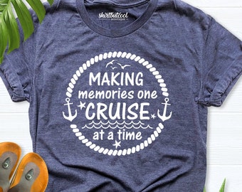 May include: A navy blue t-shirt with a white circle design. The circle has a rope border and the text "MAKING memories one *CRUISE* at a time" inside. There are two anchors and three birds inside the circle.