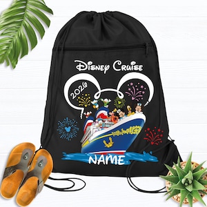 May include: A white ceramic mug with a black handle and the text "But First, Coffee" in a bold, black font. The mug is set against a blurred background, suggesting a cozy setting.