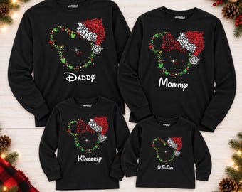 May include: Four black long-sleeve shirts featuring a graphic of a Mickey Mouse silhouette formed by red, green, and white dots, topped with a Santa hat. The shirts are personalized with the white text Daddy, Mommy, Kimberly, and William.