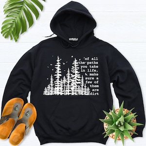 May include: Black hooded sweatshirt with a white graphic of a forest and the text 'of all the paths you take in life, make sure a few of them are dirt'.