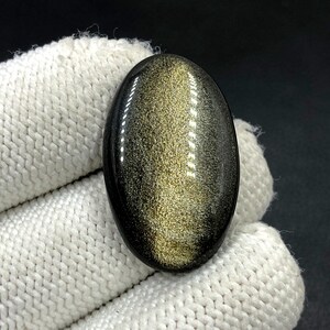 Obsidiaan cabochon goudglans... Ovale cabochon... 31 x 20 x 5 mm... 24 kt... A#N5440