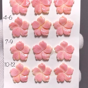 May include: Twelve carved pink flower-shaped gemstones. The gemstones are arranged in three rows of four, with each flower having five petals. The gemstones are a light pink color with a glossy finish. The image also includes the text "1-3", "4-6", "7-9", "10-12", "20m", and "12 Pcs".