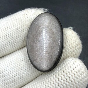 Obsidiaan cabochon zilverglans... Ovale cabochon... 31 x 20 x 6 mm... 26 kts... A#N5651