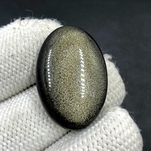 Obsidiaan cabochon goudglans... Ovale cabochon... 30 x 20 x 7 mm... 29 kts... A#N5445
