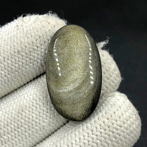 Cabochon en obsidienne dorée lustré... Cabochon ovale... 30 x 17 x 5 mm... 20 Cts... A#N5443