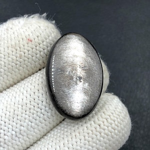 Obsidiaan cabochon zilverglans... Ovale cabochon... 28 x 18 x 6 mm... 21 kt... A#N5659