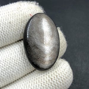 Obsidiaan cabochon zilverglans... ovale cabochon... 30 x 19 x 7 mm... 26 kts... A#N5650