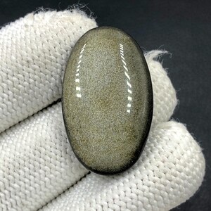 Obsidiaan cabochon goudglans... ovale cabochon... 32 x 20 x 7 mm... 29 kts... A#N5434