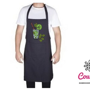 May include: A black apron with an embroidered design of a glass of lime juice with a straw and lime slices. The design is in green, yellow, and orange.