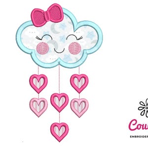 May include: An embroidered cloud design with a pink bow, smiling face, and hanging hearts. The cloud is light blue with a patterned interior of stars and moons. Six pink hearts dangle below. The CouCou Embroidery Designs logo is in the lower right.