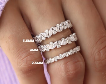 May include: Three silver rings with a leaf design and clear stones. The rings are labeled 2.5mm, 4mm, and 5.5mm.