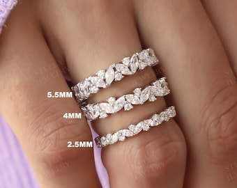 May include: Three silver rings with a leaf design and clear stones. The rings are labeled 2.5mm, 4mm, and 5.5mm.