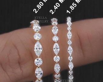 May include: Three gold rings with marquise-shaped diamonds. The rings are 2.80 mm, 2.40 mm, and 1.85 mm wide.