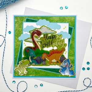 DINO, card biglietto di auguri compleanno fatto a mano nei toni del verde e azzurro  con cinque simpatici dinosauri per bimbo