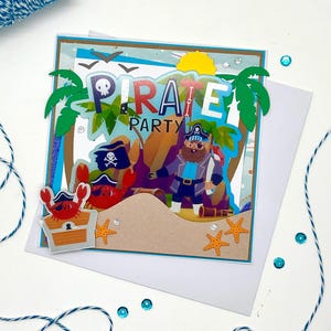 L’ISOLA del TESORO, card biglietto di auguri compleanno fatto a mano nei toni dell’  azzurro  con simpatico pirata e forziere per bimbo
