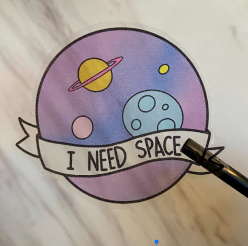 May include: A clear sticker with a purple, blue, and pink gradient background. The sticker features a cartoon illustration of planets and stars with the text "I NEED SPACE".