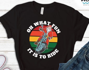 May include: Black t-shirt with a retro-style graphic of Santa Claus riding a motorcycle. The graphic says "Oh What Fun It Is To Ride".