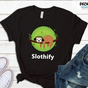 May include: Black t-shirt with a green circle and a cartoon sloth wearing headphones. The text "Slothify" is printed below the sloth.