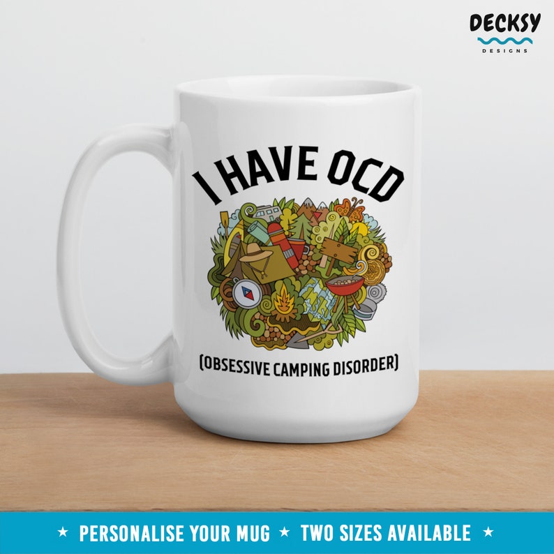 May include: White ceramic mug with a black graphic that says "I HAVE OCD (OBSESSIVE CAMPING DISORDER)". The graphic is a heart shape filled with camping-related doodles.