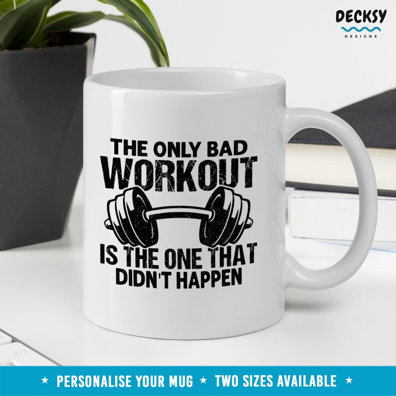 May include: White ceramic mug with a black graphic that reads "The only bad workout is the one that didn't happen." The graphic also features a black barbell with weights on each end.