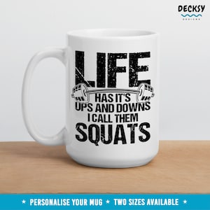 May include: White ceramic mug with a black graphic that reads "Life has it's ups and downs I call them squats".
