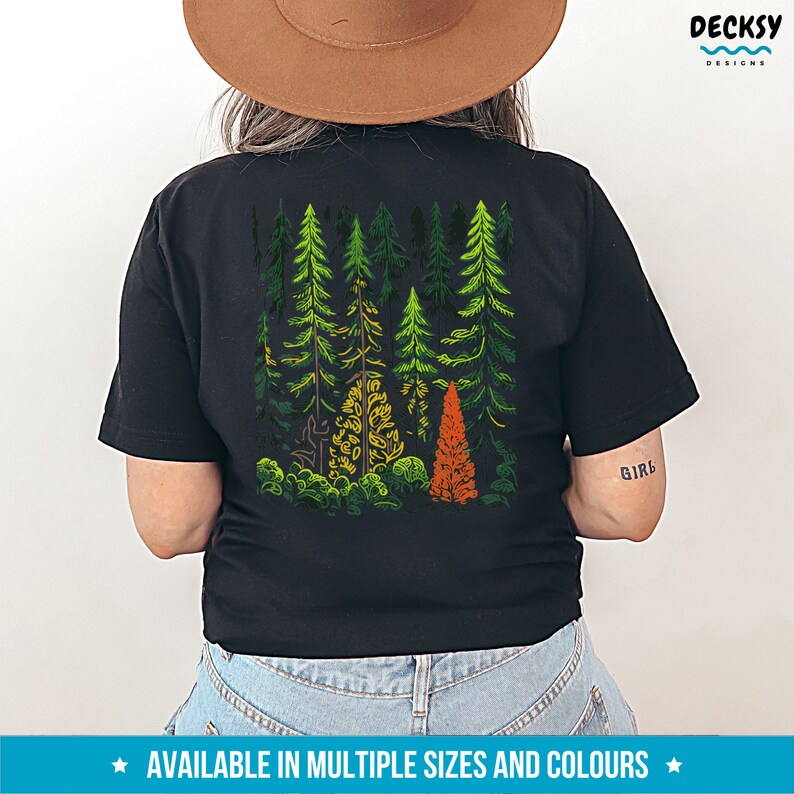 May include: Black t-shirt with a graphic print of a forest scene with green and orange trees. The text "Girl" is printed on the right sleeve.