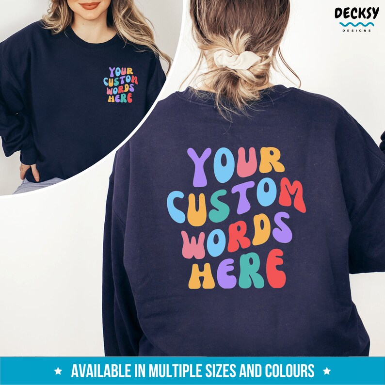 May include: A navy blue sweatshirt with the text "YOUR CUSTOM WORDS HERE" in colorful, rounded letters. The text is on the back of the sweatshirt.