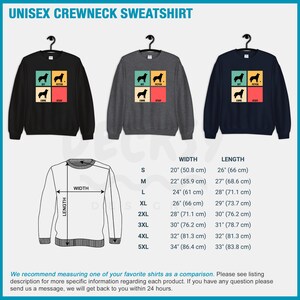 Op de afbeelding: Unisex crewneck sweatshirt in zwart, grijs en marineblauw met een retro-stijl grafische afbeelding van een hond met de woorden "Sit, Fetch, Come, Stay". Maattabel met afmetingen in inches en centimeters.