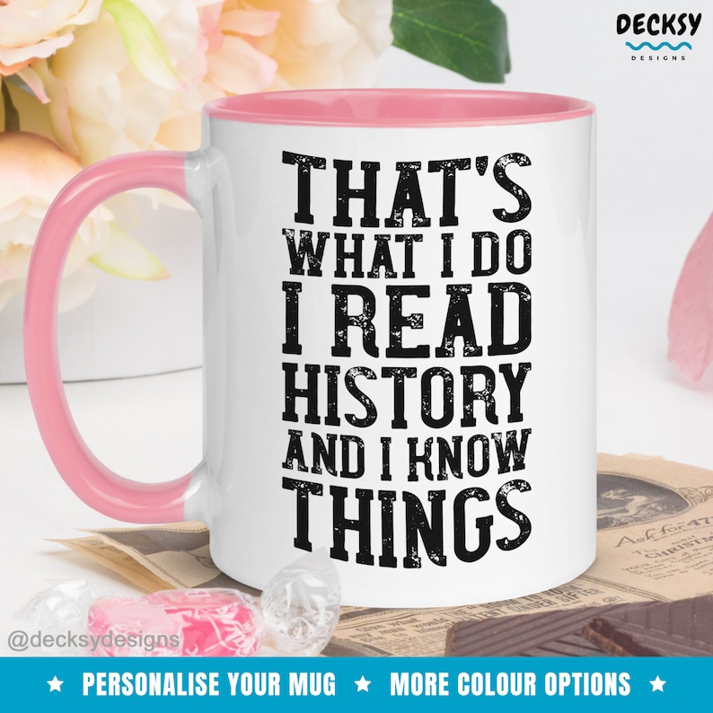 May include: White ceramic mug with a pink rim. The mug has a black graphic that reads "That's what I do I read history and I know things".