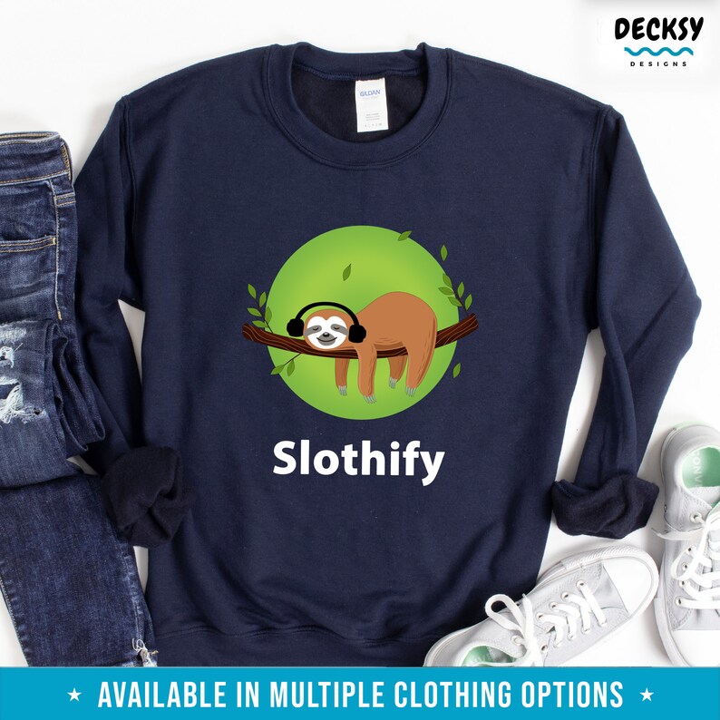 May include: A navy blue sweatshirt with a green circle and a sloth wearing headphones. The text "Slothify" is printed below the sloth.