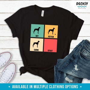 May include: Black t-shirt with a retro-style design featuring a silhouette of a dog and the words "Sit", "Fetch", "Come", and "Stay".