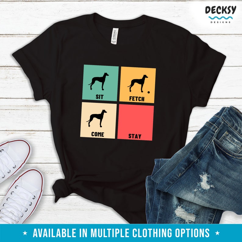 May include: Black t-shirt with a retro-style design featuring a silhouette of a dog and the words "Sit", "Fetch", "Come", and "Stay".