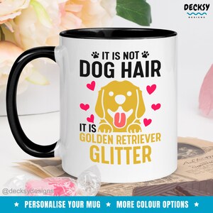 May include: White ceramic coffee mug with a black rim and handle. The mug features a golden retriever dog illustration with the text "It is not dog hair, it is golden retriever glitter".