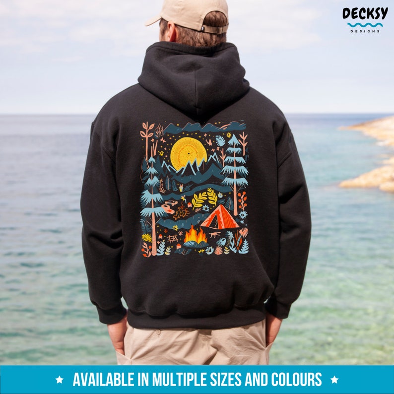 May include: Black hooded sweatshirt with a colorful illustration of a campsite scene with a tent, campfire, and mountains. The illustration is surrounded by a white border.