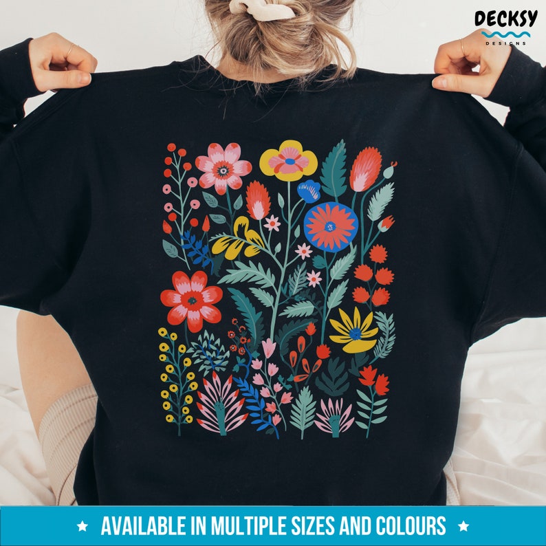 May include: Black sweatshirt with a colorful floral design printed on the back. The design features a variety of flowers in shades of red, pink, yellow, blue, and green.