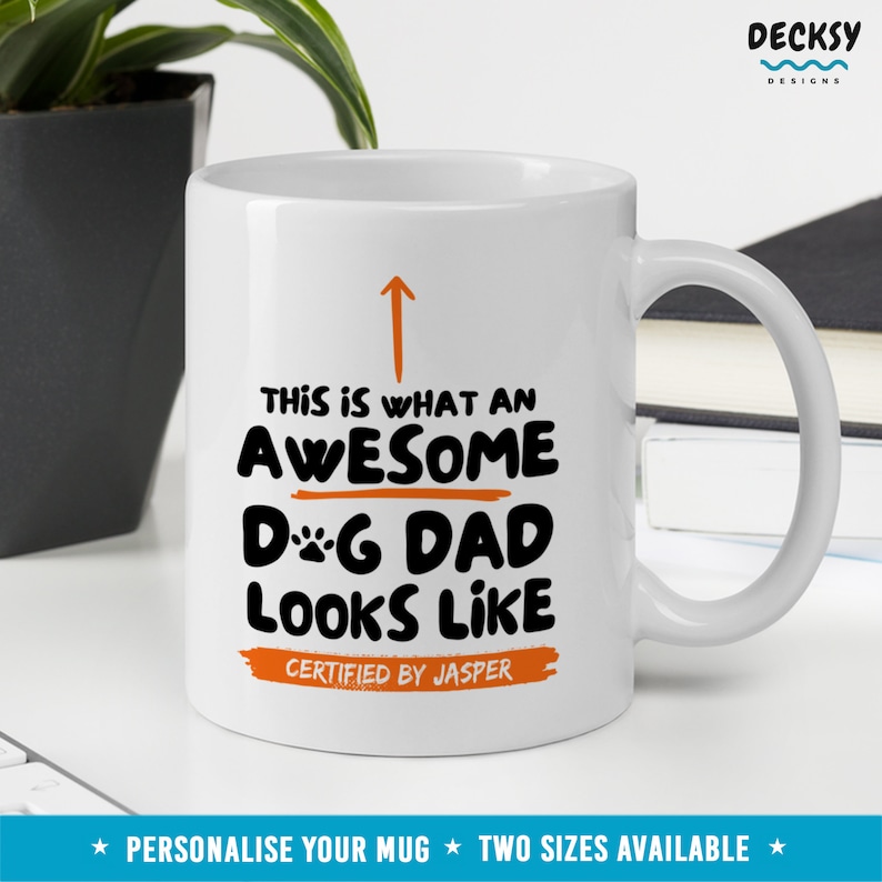 May include: White ceramic mug with a black and orange design that says "This is what an awesome dog dad looks like" with the text "Certified by Jasper" below.