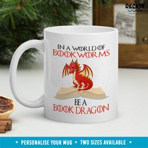 May include: White ceramic mug with a red dragon illustration and the text "In a world of bookworms be a book dragon".
