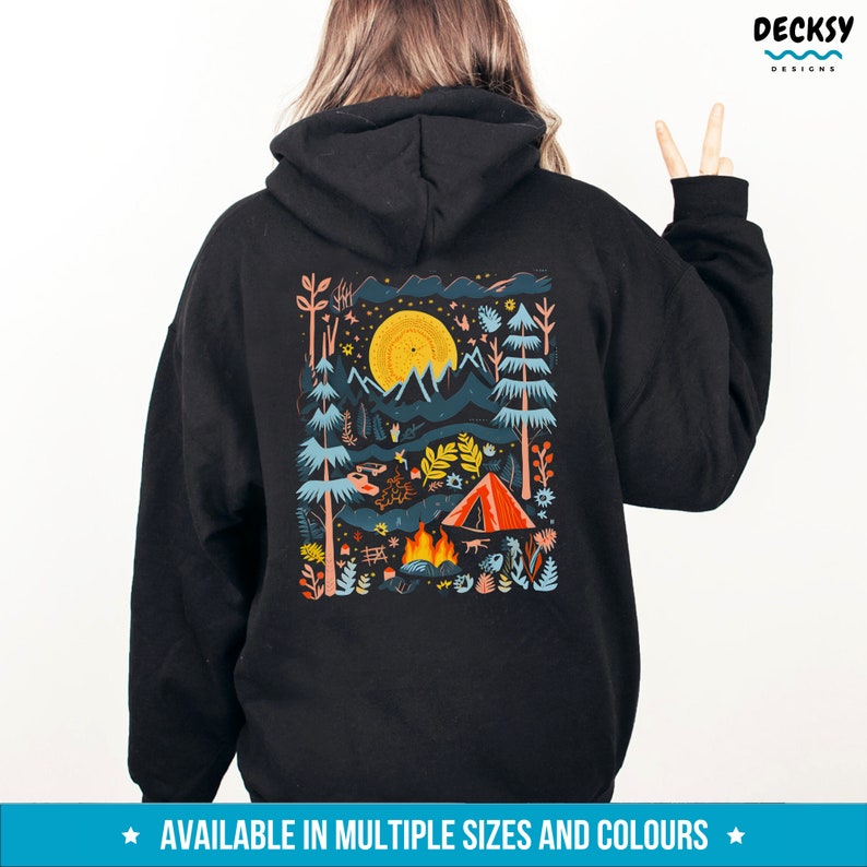 May include: Black hooded sweatshirt with a colorful illustration of a campsite scene on the back. The illustration features a tent, a campfire, mountains, trees, and a bright yellow sun.