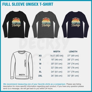 May include: A black, heather grey, and navy blue long-sleeved t-shirt with a vintage-style graphic that says "I'm not old, I'm vintage". The t-shirt is available in sizes XS-2XL. The size chart shows the width and length of each size in inches and centimeters.
