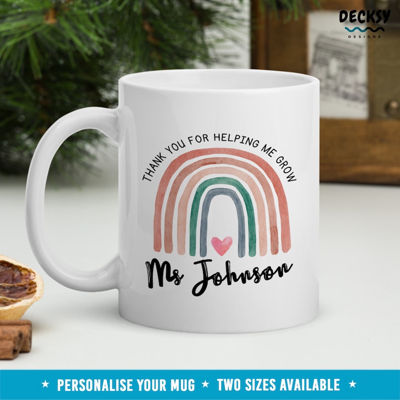 May include: White ceramic mug with a rainbow design and the text "Thank you for helping me grow Ms Johnson".