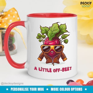 May include: White ceramic mug with a red rim and handle. The mug features a cartoon beetroot wearing sunglasses and a brown jacket. The text "A little off-beet" is printed below the beetroot.