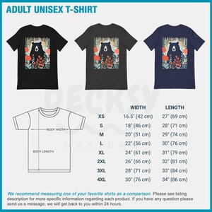 May include: Adult unisex t-shirt featuring a black bear with red flowers in a forest setting. The t-shirt is available in black, heather grey, and navy blue. Size chart with width and length measurements in inches and centimeters.