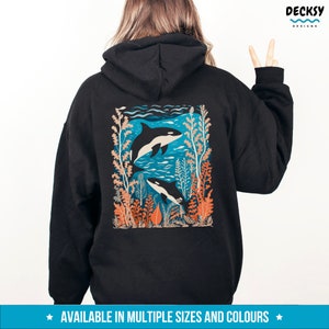 May include: Black hoodie with a graphic print of two orcas swimming in a blue ocean with coral and seaweed. The graphic is in a retro style with orange, blue, and white colors.