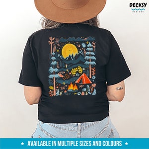 May include: Black t-shirt with a colorful illustration of a campsite scene with a tent, campfire, and trees. The text "Girl" is printed on the right sleeve.
