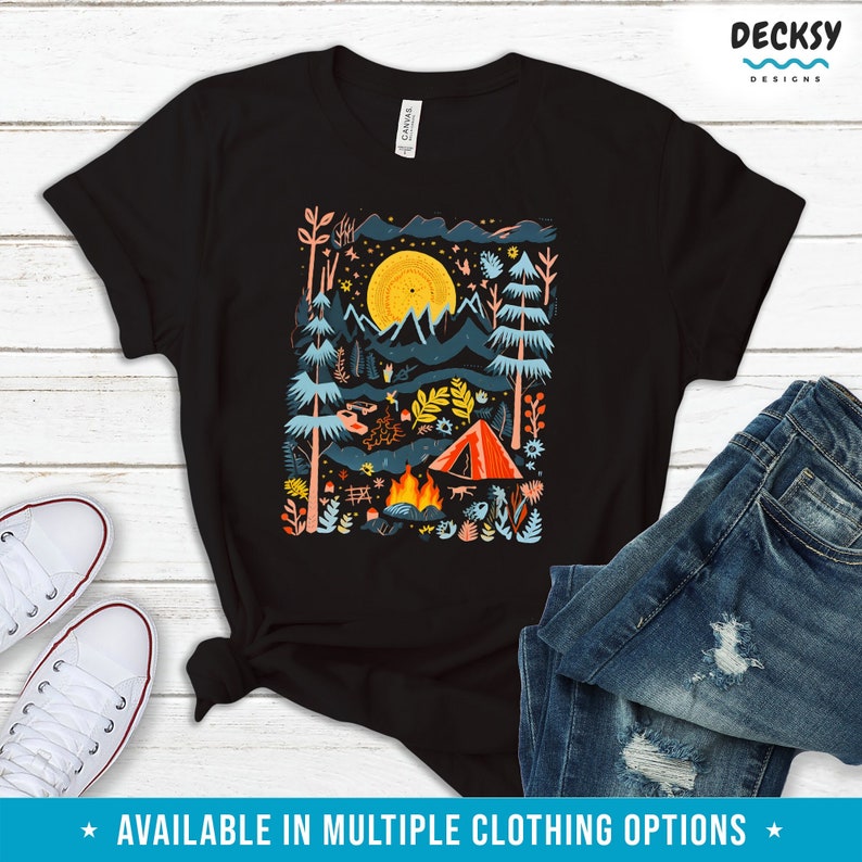May include: A black t-shirt with a colorful illustration of a campsite in the woods. The illustration features a tent, a campfire, trees, and a full moon. The design is perfect for nature lovers and campers.