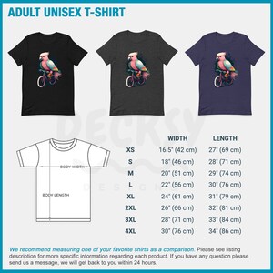 May include: A black, grey, and blue unisex t-shirt with a pink cockatoo riding a bicycle graphic. The t-shirt is available in sizes XS to 4XL. The size chart shows the width and length of each size in inches and centimeters.