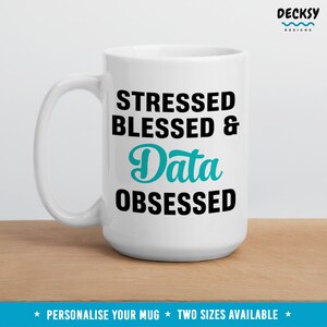 May include: White ceramic mug with black text that reads "Stressed Blessed & Data Obsessed". The word "Data" is in teal blue.