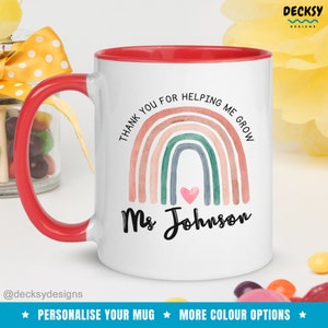 May include: White ceramic mug with a red rim and handle. The mug features a watercolor rainbow with the text "Thank you for helping me grow" and "Ms Johnson".