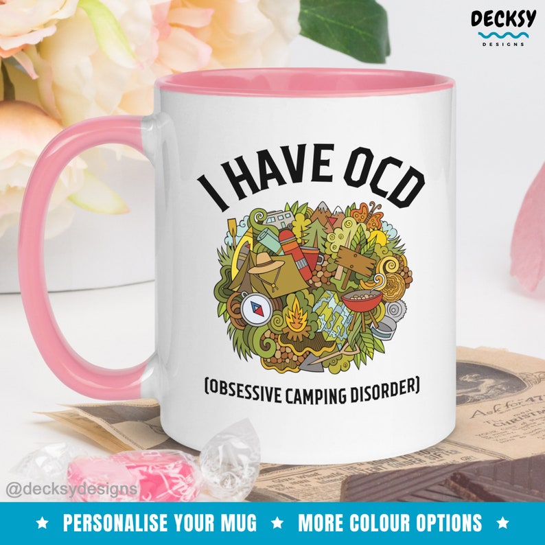 May include: White ceramic mug with a pink rim and handle. The mug has a black graphic that says "I HAVE OCD (OBSESSIVE CAMPING DISORDER)" with a doodle of camping related items.